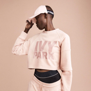 Pink cropped sweater with text: IVY PARK